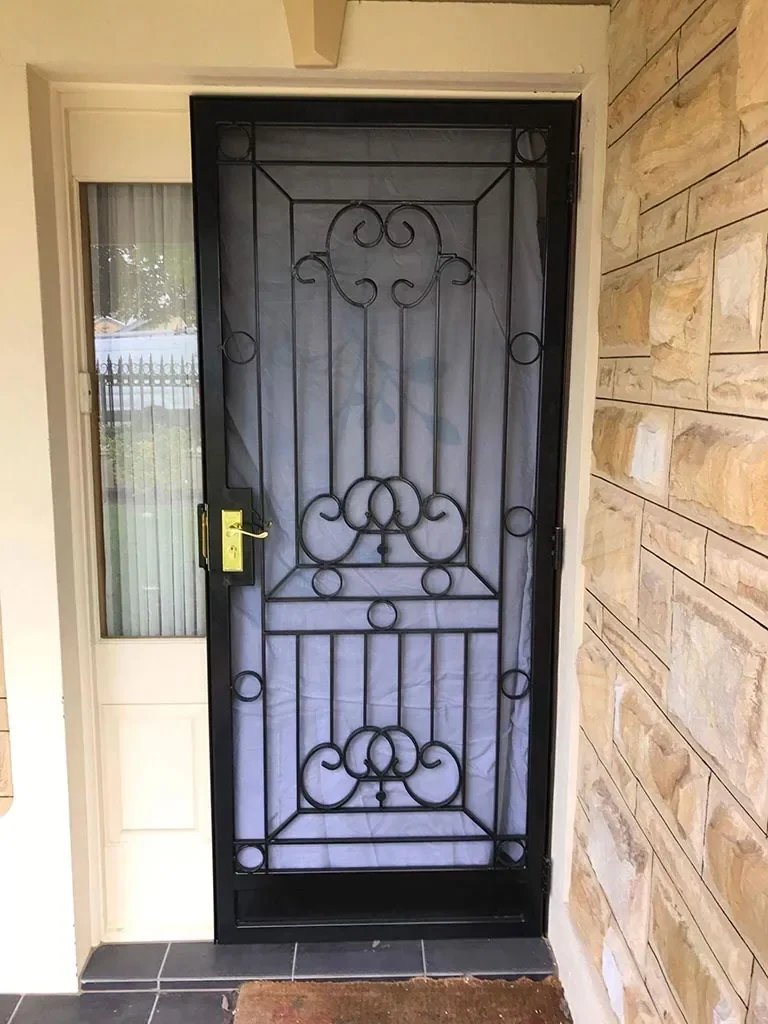 Decorative black steel security screen door fitted to a home