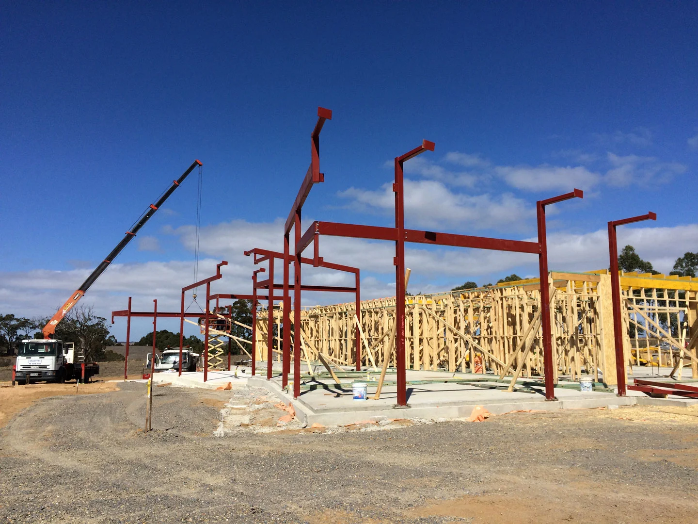 Crane installing structural steel for a new house