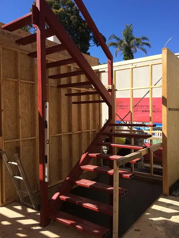 Red structural steel staircase fabricated for a building project