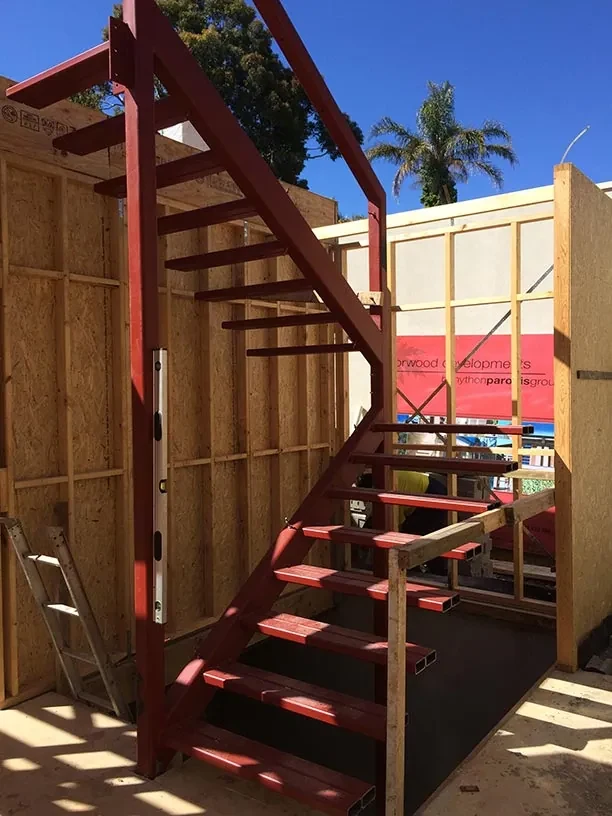 Red structural steel staircase fabricated for a building project
