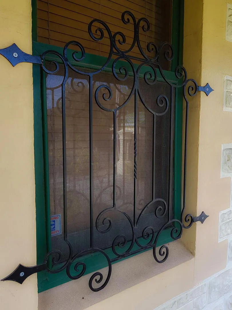 Decorative wrought iron security grille over a window